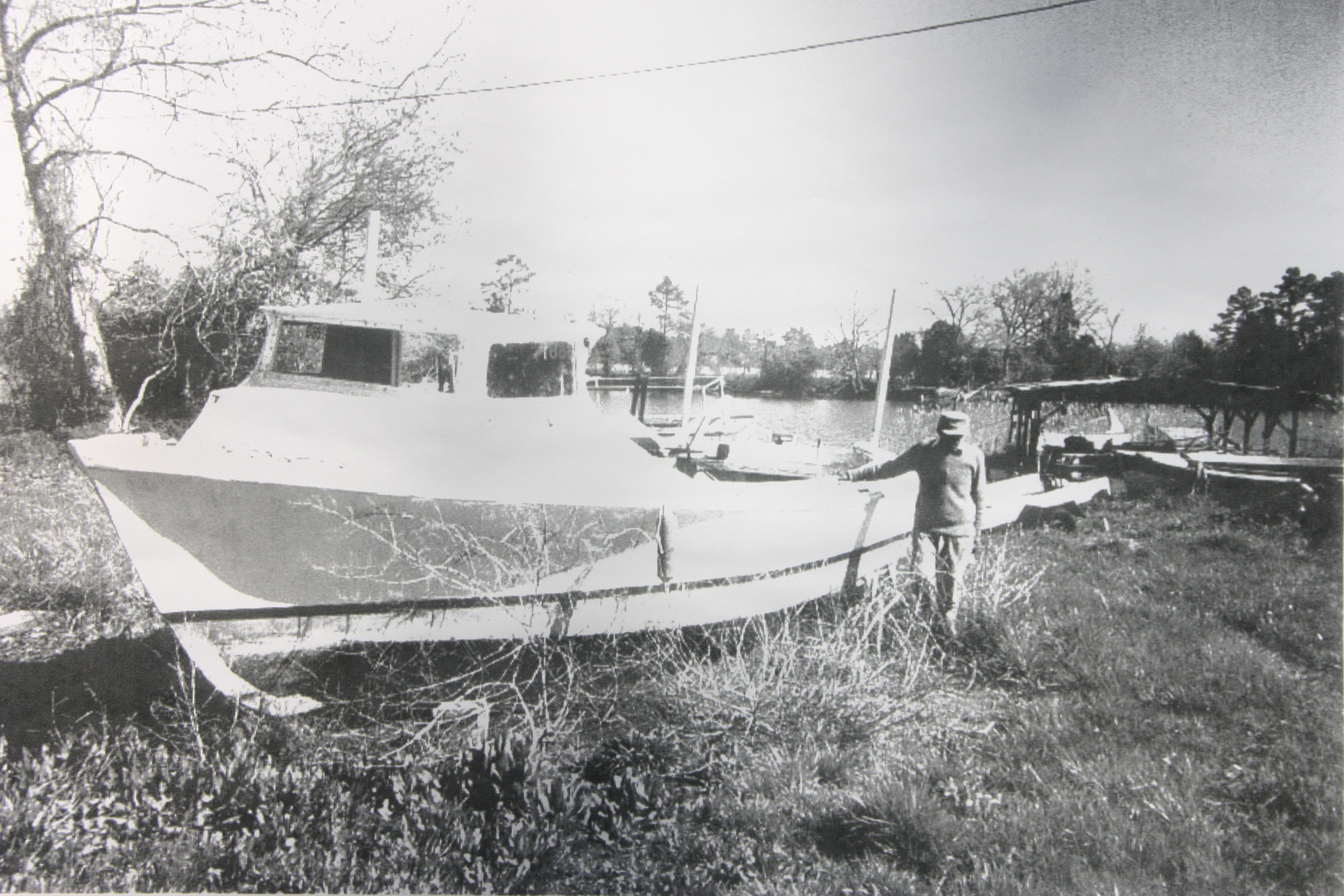 Samuel Eddie Turner and one of the boats he built. 